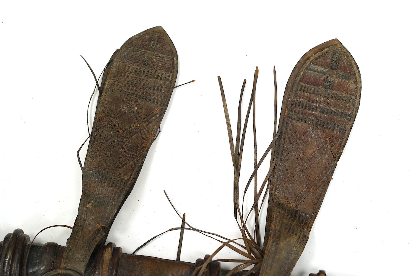 A late 19th century Nigerian Taboura from the Hausa People of Northern Nigeria, in leather scabbard, blade 55.5cm. Condition - good